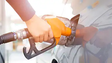 A person pumping gas into a car.