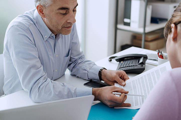 Man going over documents with a client.
