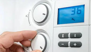 A person adjusting a home thermometer.